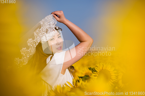 Image of asian woman at sunflower field