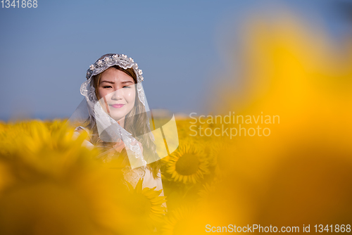 Image of asian woman at sunflower field