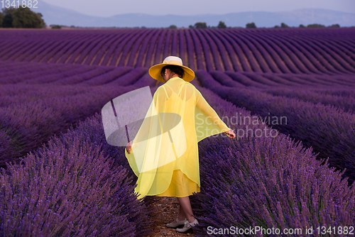 Image of asian woman in yellow dress and hat at lavender field