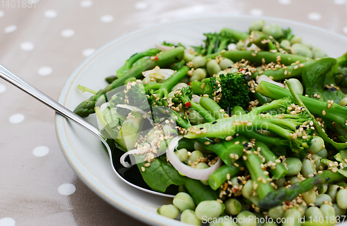 Image of Serving spoon in a spring salad of broccolini and beans