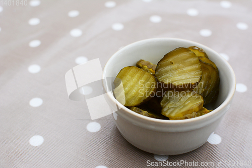 Image of Slices of juicy, sour gherkins in a ceramic pot