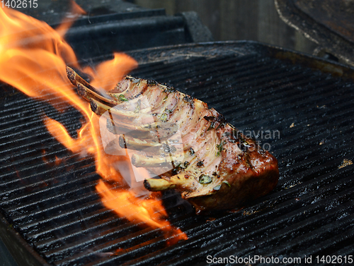 Image of Large grilled rack of lamb over an open flame