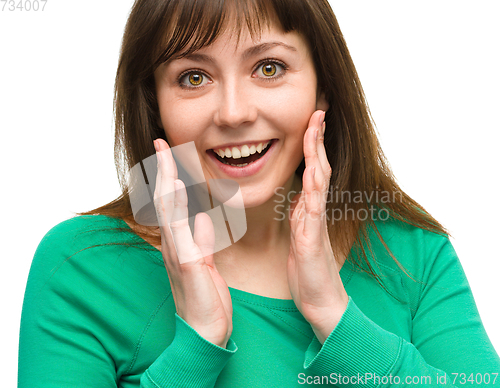 Image of Woman is holding her face in astonishment