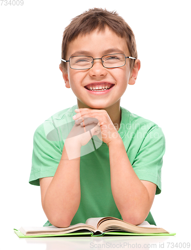 Image of Little boy is reading a book