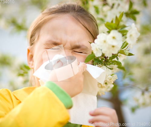 Image of Little girl is blowing her nose