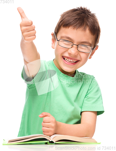 Image of Little boy is reading a book
