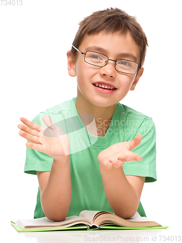 Image of Little boy is reading a book