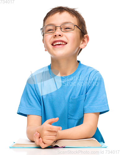 Image of Little boy is reading a book