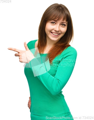Image of Portrait of a young woman pointing to the left