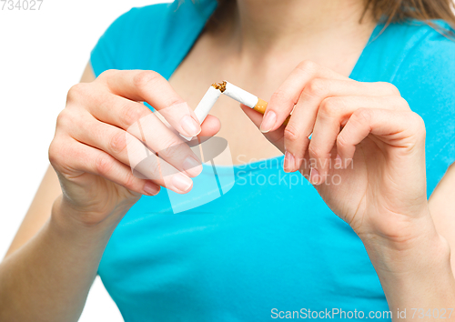 Image of Young woman is breaking a cigarette