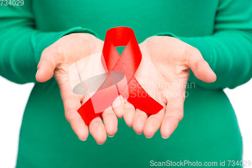 Image of Woman is holding the red awareness ribbon