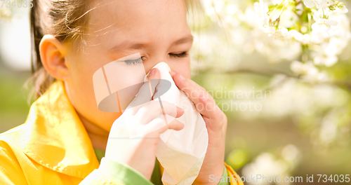 Image of Little girl is blowing her nose