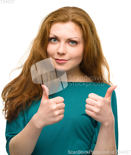 Image of Woman is showing thumb up gesture