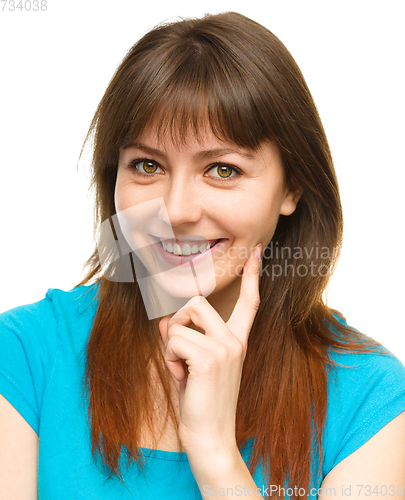 Image of Young woman is supporting her head with hand
