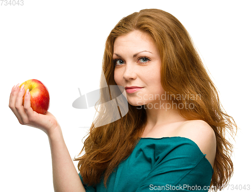 Image of Young happy girl with apple