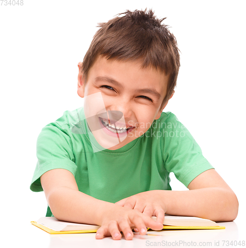 Image of Little boy is reading a book