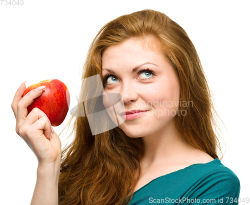 Image of Young happy girl with apple