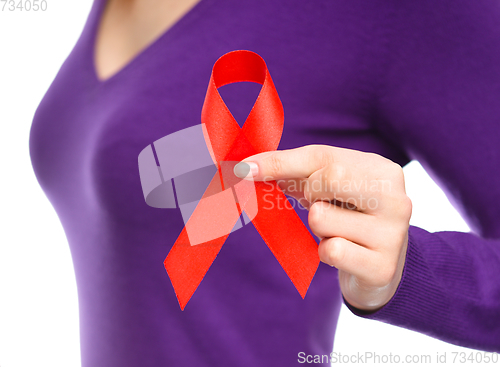 Image of Woman is holding the red awareness ribbon