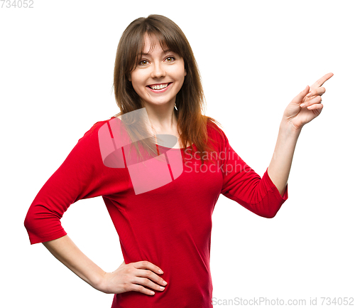 Image of Portrait of a young woman pointing to the right