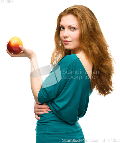 Image of Young happy girl with apple