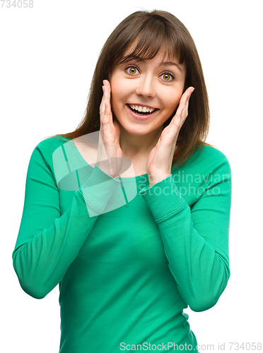 Image of Woman is holding her face in astonishment