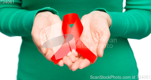 Image of Woman is holding the red awareness ribbon