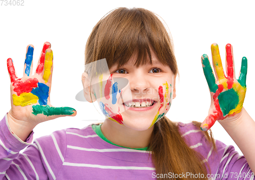 Image of Portrait of a cute girl playing with paints