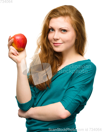 Image of Young happy girl with apple