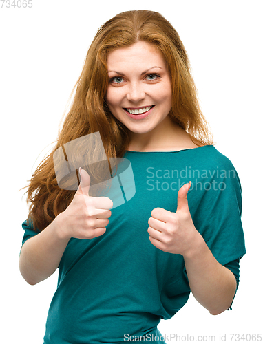 Image of Woman is showing thumb up gesture