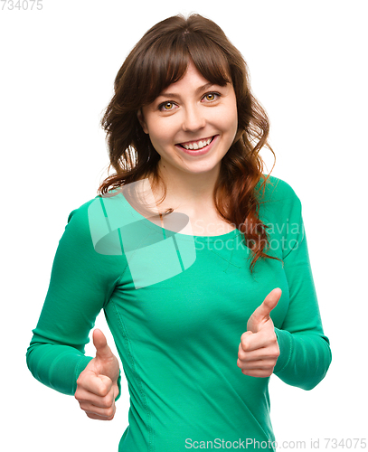 Image of Woman is showing thumb up gesture