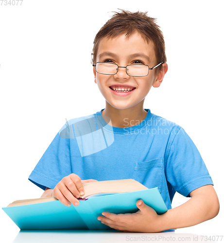 Image of Little boy is reading a book
