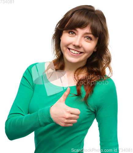 Image of Woman is showing thumb up gesture