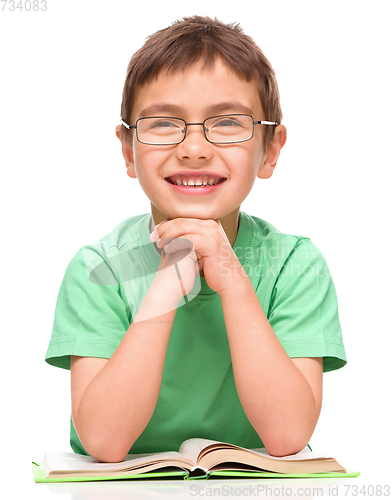 Image of Little boy is reading a book