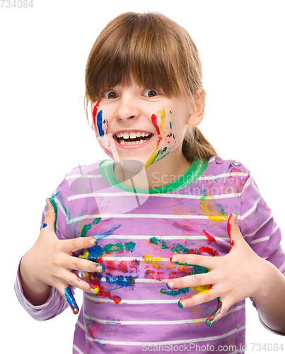 Image of Portrait of a cute girl playing with paints