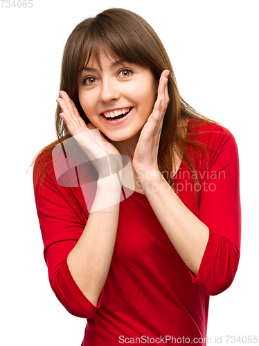 Image of Woman is holding her face in astonishment