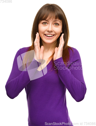 Image of Woman is holding her face in astonishment