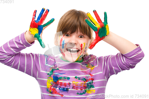 Image of Portrait of a cute girl playing with paints