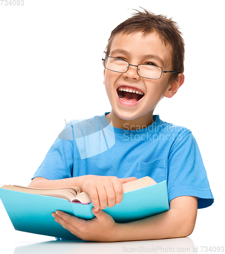 Image of Little boy is reading a book
