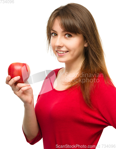 Image of Young happy girl with apple