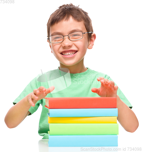 Image of Little boy is reading a book