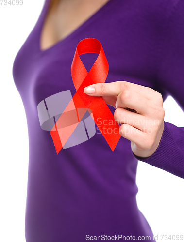 Image of Woman is holding the red awareness ribbon