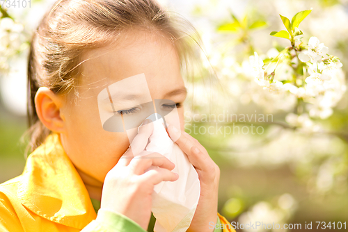 Image of Little girl is blowing her nose