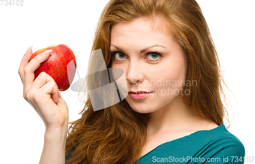 Image of Young happy girl with apple