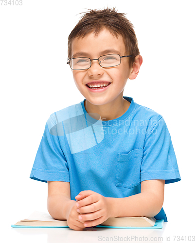 Image of Little boy is reading a book