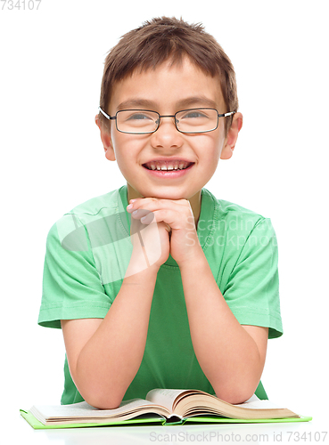 Image of Little boy is reading a book