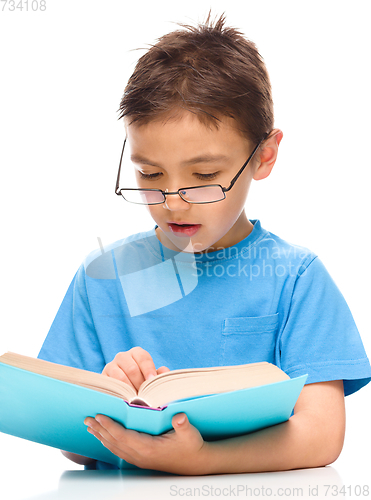 Image of Little boy is reading a book