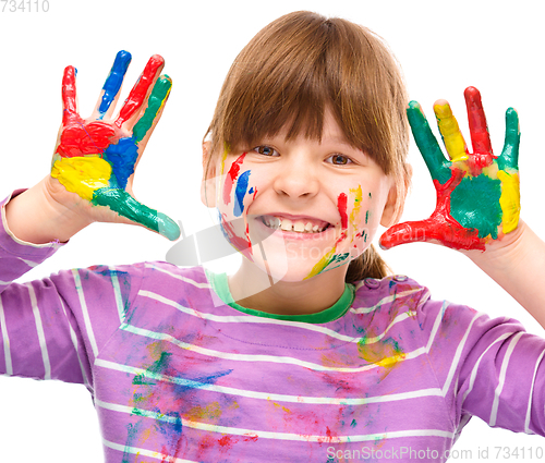 Image of Portrait of a cute girl playing with paints