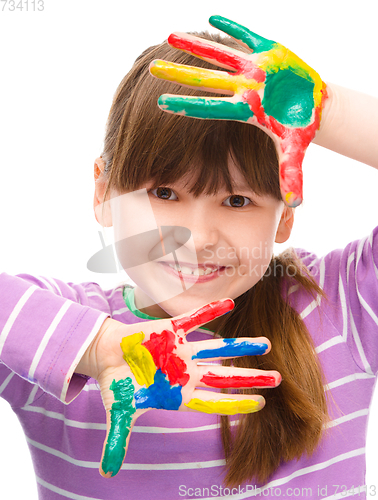 Image of Portrait of a cute girl playing with paints