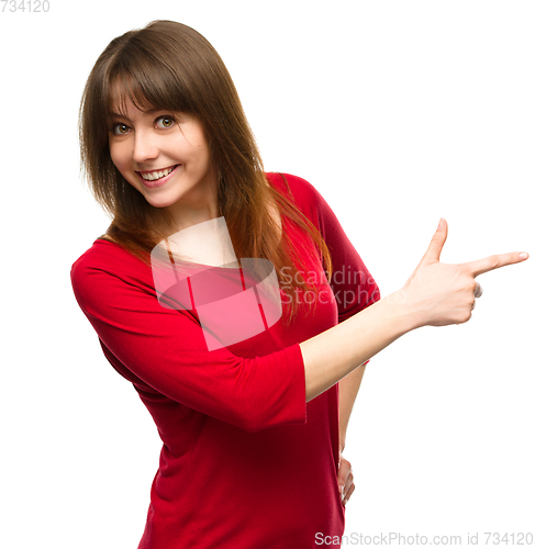 Image of Portrait of a young woman pointing to the right