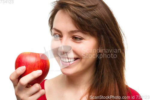 Image of Young happy girl with apple